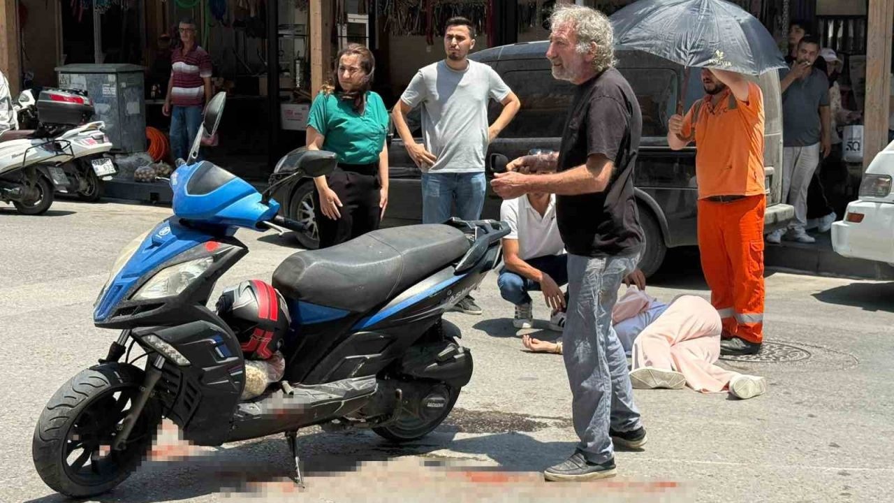 Kazada yaralanan genç kadına esnaftan şemsiyeli destek